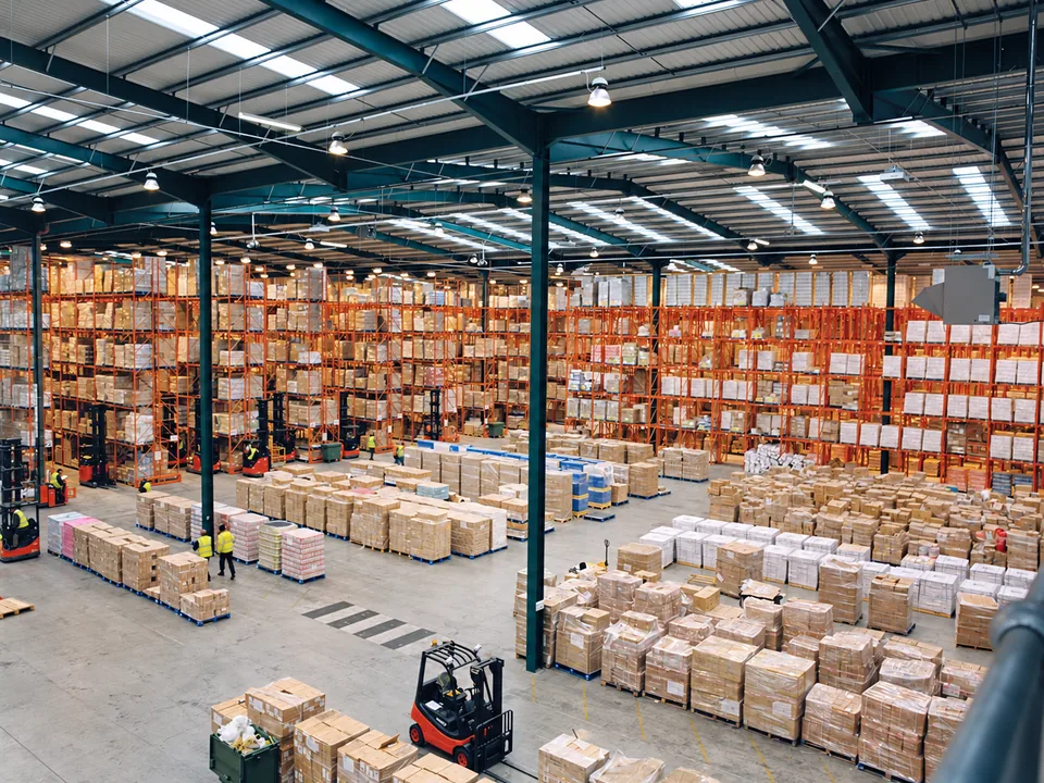 Pallet racks and packed cartons in a warehouse with clear access aisles
